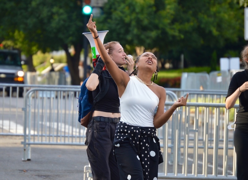 This photo is of the Roe v. Wade Protests on June 27th 2022. The photo depicts two women chanting for their reproductive rights. Both are extremely passionate, the one in the front is holder her middle finger to the sky.